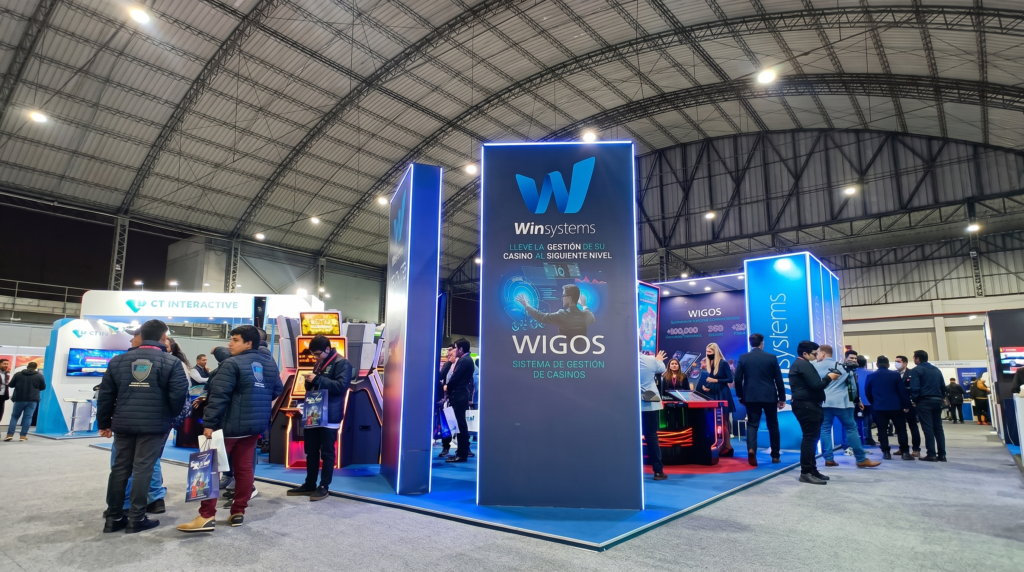 Stand comercial en una feria con espacios de exhibición y visitantes.